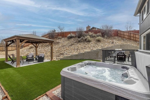 view of yard with a hot tub, a gazebo, a patio area, a fenced backyard, and an outdoor living space