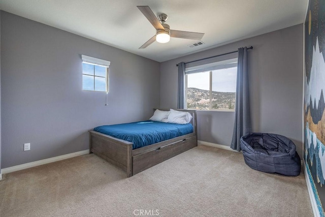 bedroom with carpet, multiple windows, and baseboards