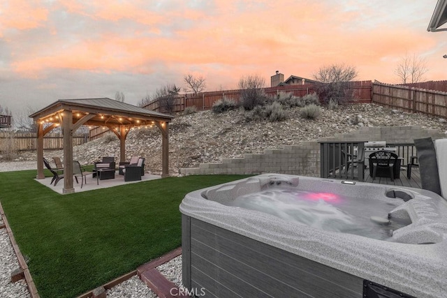 view of yard featuring a hot tub, a patio, a fenced backyard, a gazebo, and outdoor lounge area