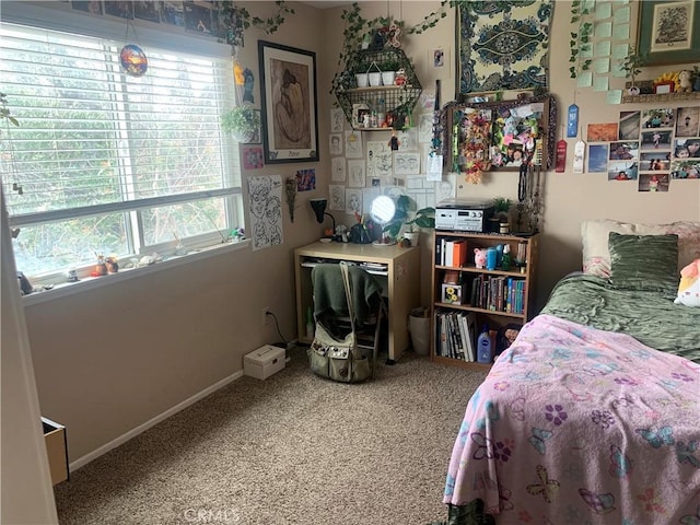 carpeted bedroom featuring baseboards