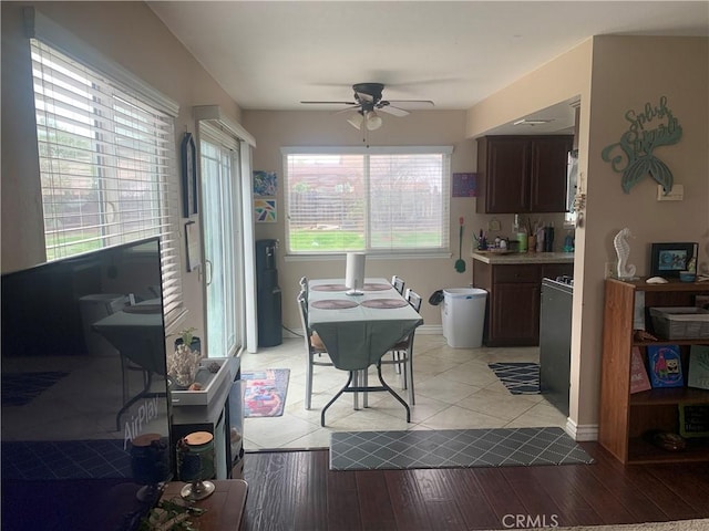 dining space featuring light wood finished floors and ceiling fan