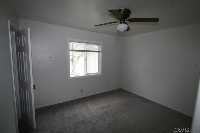 spare room with ceiling fan, carpet, and baseboards