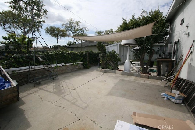 view of patio with an outbuilding and a storage shed