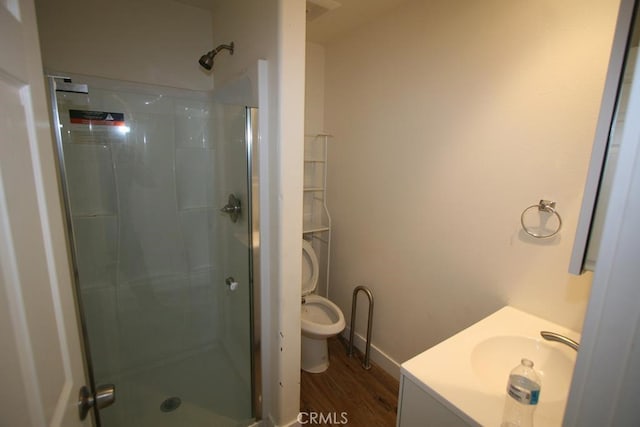 full bath with a stall shower, wood finished floors, and vanity