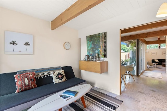 living area featuring wood ceiling, beamed ceiling, and baseboards