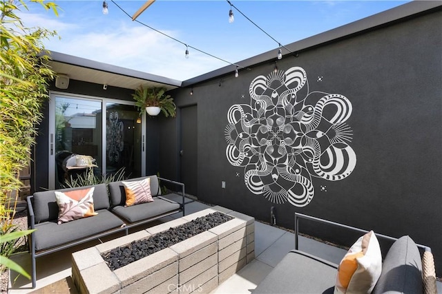 view of patio / terrace with an outdoor living space with a fire pit