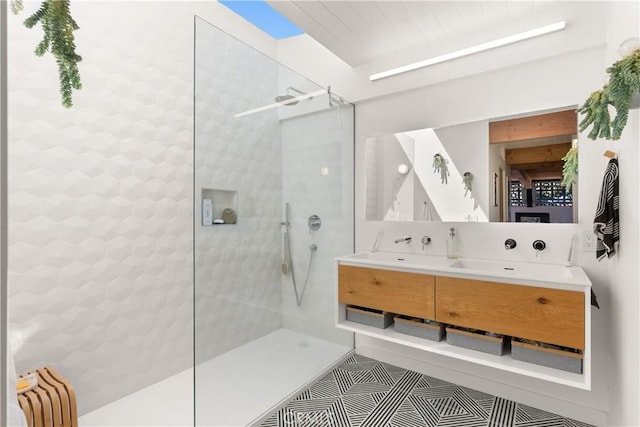 full bath with a walk in shower, double vanity, and tile patterned floors