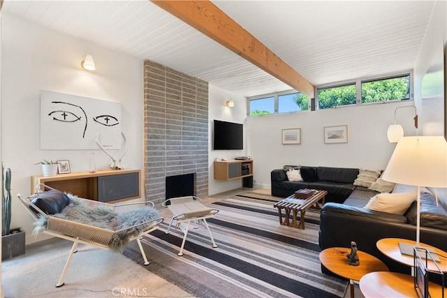 carpeted living area featuring beamed ceiling, a fireplace, and a wealth of natural light