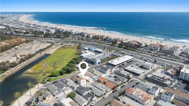 drone / aerial view featuring a water view and a view of the beach