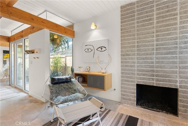 sitting room featuring a fireplace and beam ceiling