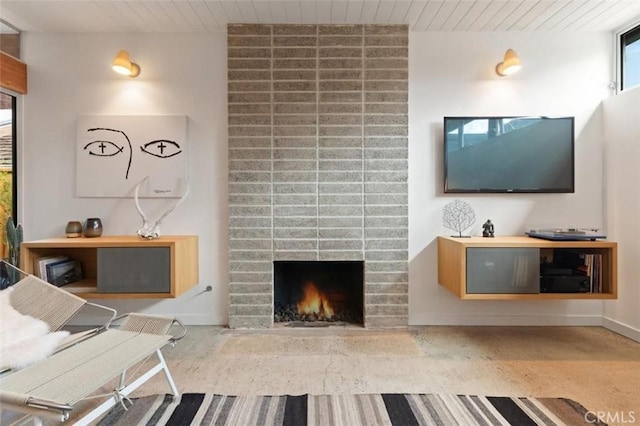 living area with wooden ceiling and a fireplace