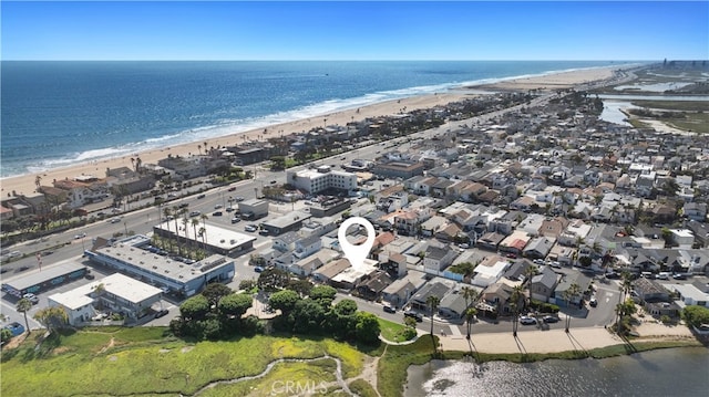 birds eye view of property with a view of the beach and a water view