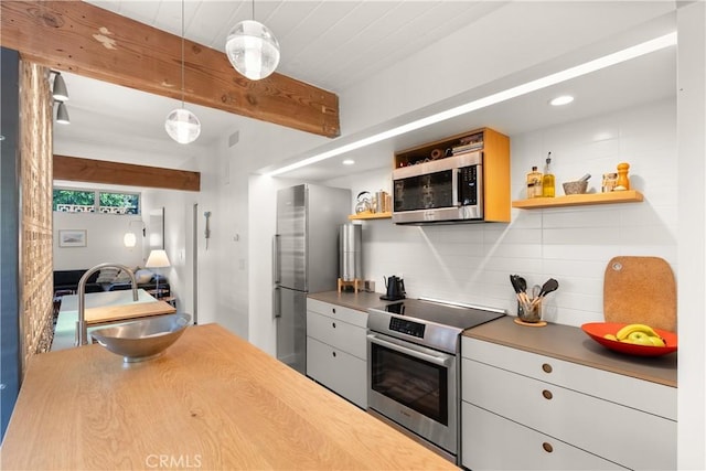 kitchen with beam ceiling, decorative light fixtures, open shelves, tasteful backsplash, and appliances with stainless steel finishes