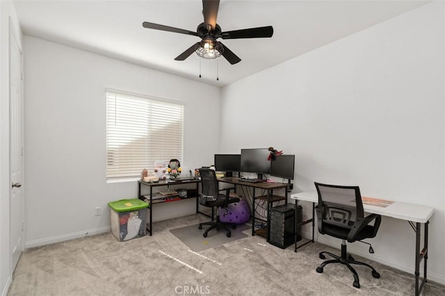 office space featuring a ceiling fan, carpet flooring, and baseboards