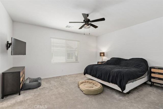 carpeted bedroom with ceiling fan and visible vents