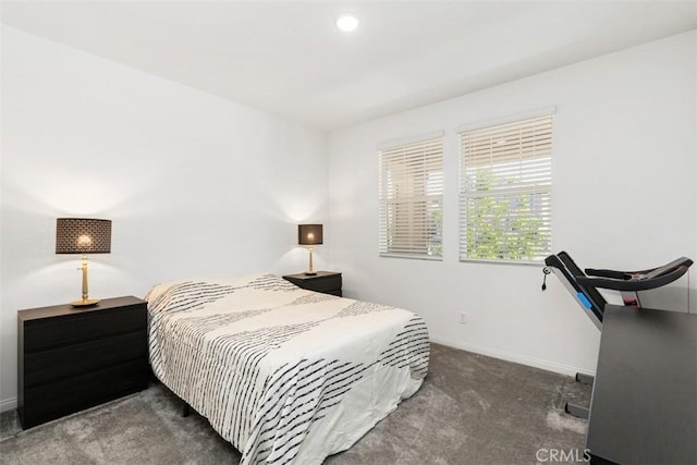 carpeted bedroom featuring baseboards