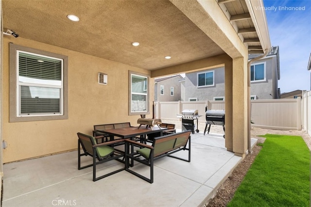 view of patio / terrace featuring a fenced backyard, a grill, and outdoor dining space