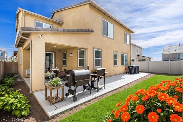 32345 Jeter Ln, Menifee, CA 92584 - back of property with stucco siding, a fenced backyard, and a patio
