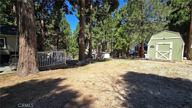 view of yard featuring a storage shed and an outbuilding