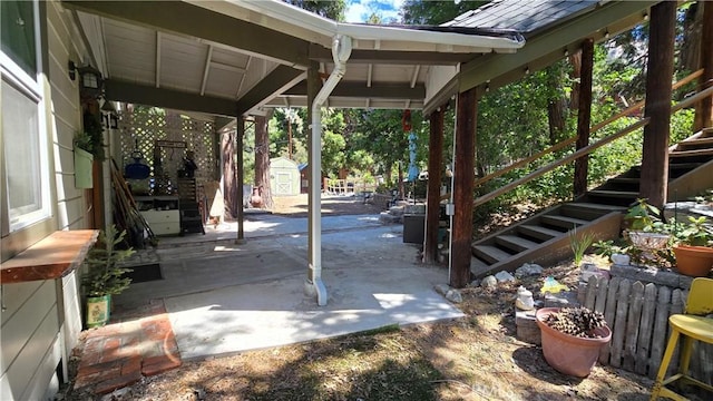 view of patio / terrace with a storage unit and an outdoor structure