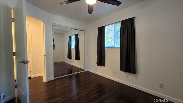 unfurnished bedroom with ceiling fan, a closet, wood finished floors, and baseboards