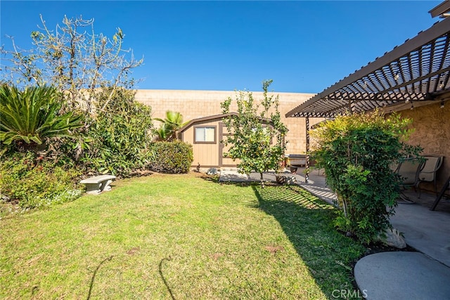 view of yard featuring an outbuilding, a patio area, and a pergola