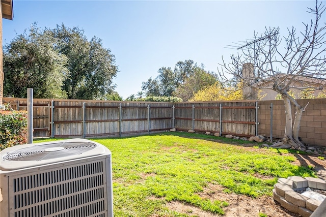 view of yard featuring a fenced backyard and central AC unit