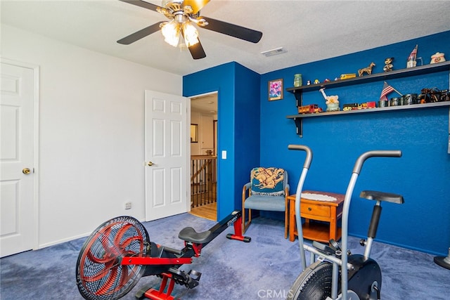 workout area featuring visible vents, ceiling fan, and carpet flooring