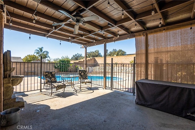 view of patio / terrace featuring fence, a fenced in pool, and a ceiling fan