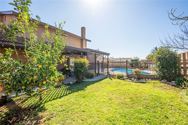 view of yard with a patio area, fence, and a fenced in pool