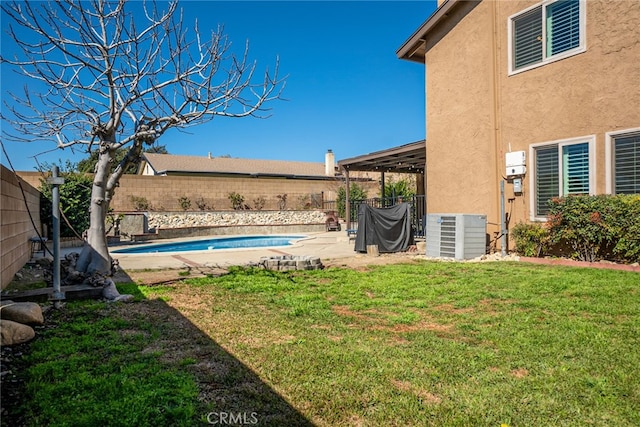 view of yard with a patio, central AC unit, a fenced backyard, and a fenced in pool