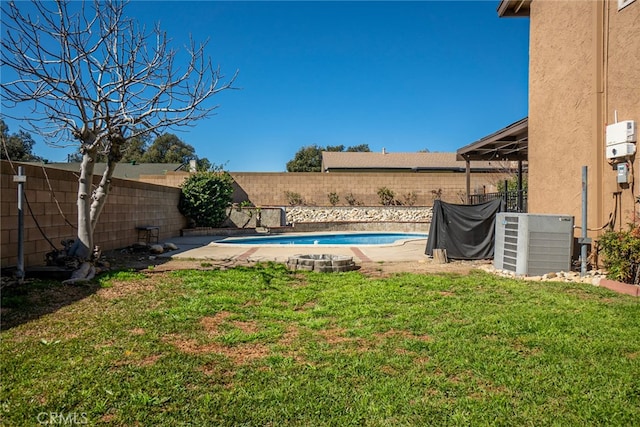 view of yard with a fenced in pool, a fenced backyard, and central air condition unit