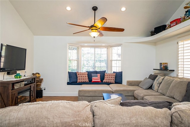 living room with recessed lighting, wood finished floors, a ceiling fan, baseboards, and a glass covered fireplace