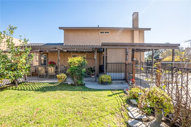 back of property featuring a patio, fence, a yard, a pergola, and stucco siding