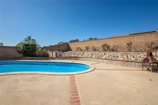 view of swimming pool featuring a fenced backyard, a fenced in pool, and a patio