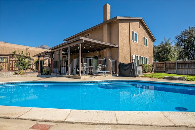 view of pool with a fenced in pool, a patio area, and fence