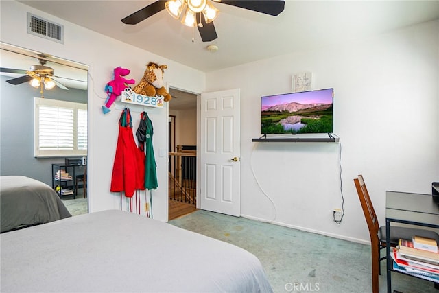 bedroom featuring ceiling fan, carpet floors, visible vents, and baseboards