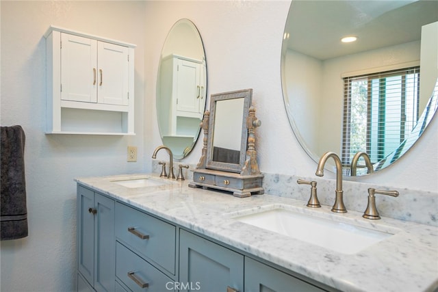 full bath with recessed lighting, a sink, and double vanity