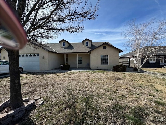 view of front of property with an attached garage, a shingled roof, fence, and stucco siding