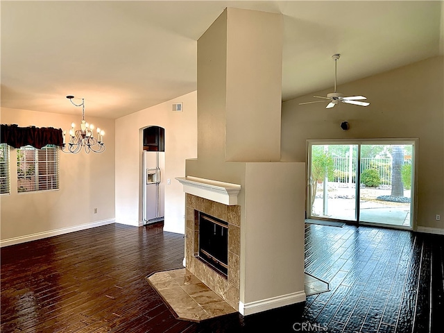 unfurnished living room featuring dark wood-style floors, a fireplace, visible vents, baseboards, and ceiling fan with notable chandelier