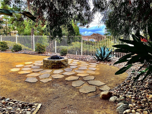 view of yard featuring a fire pit and fence