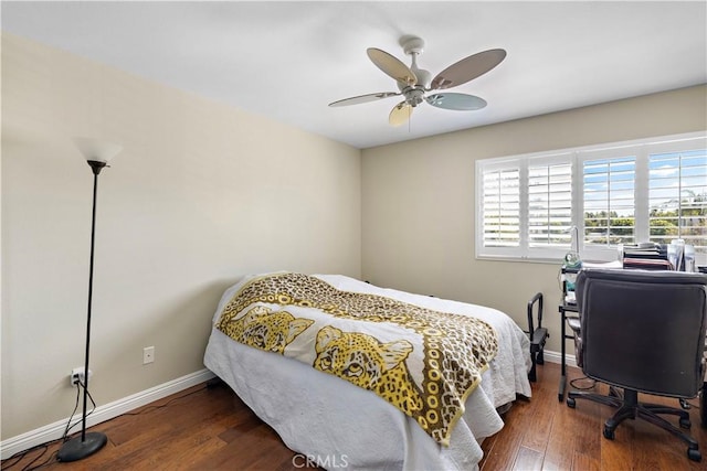 bedroom featuring ceiling fan, baseboards, and wood finished floors