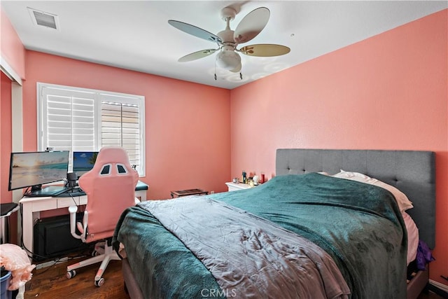 bedroom featuring visible vents, ceiling fan, and wood finished floors