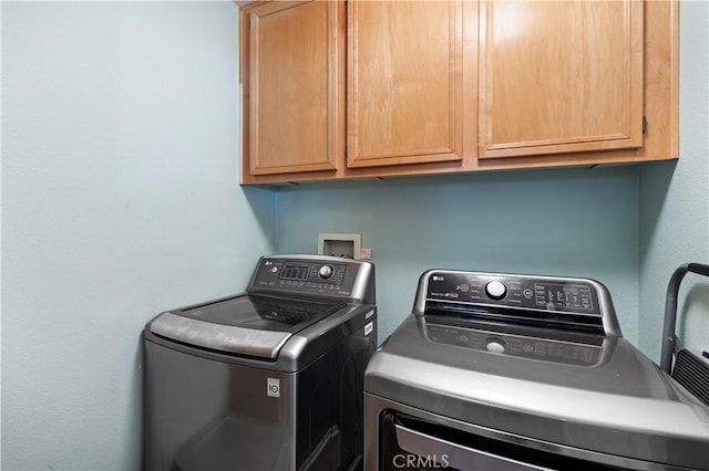 laundry room featuring washing machine and dryer and cabinet space