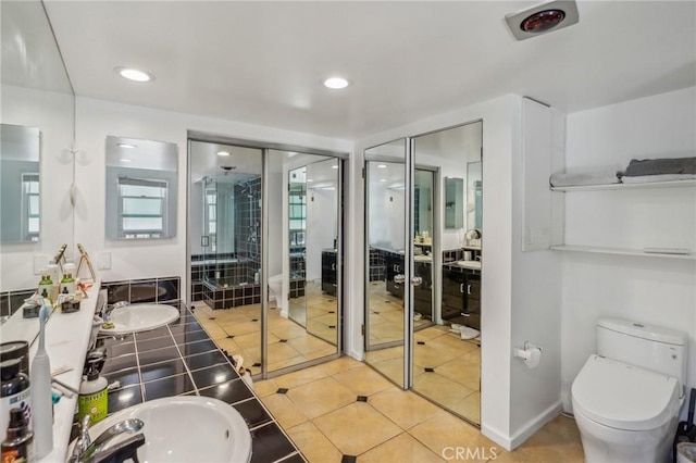 bathroom with recessed lighting, tile patterned flooring, a sink, and a shower stall