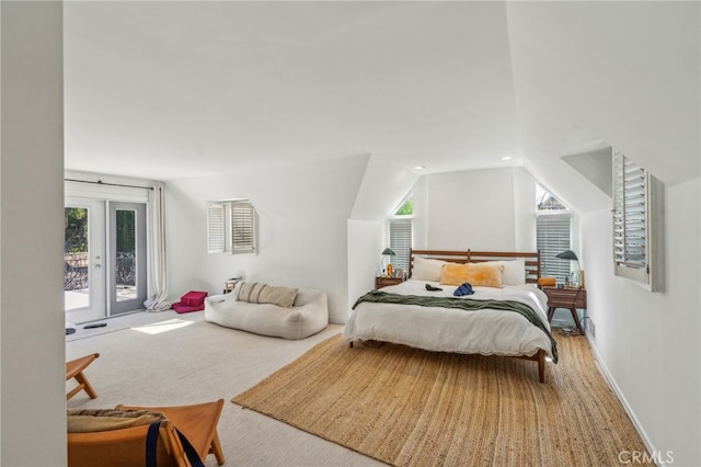 bedroom with french doors, multiple windows, carpet flooring, and access to exterior