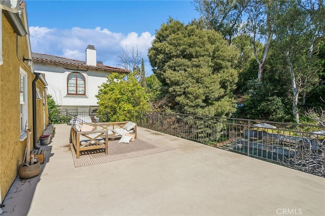 view of patio / terrace with fence and an outdoor living space