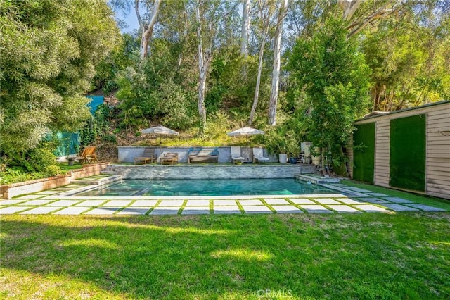 outdoor pool with a patio area and a yard