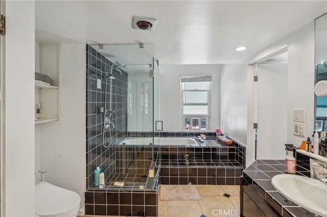 bathroom with toilet, a stall shower, tile patterned flooring, and a garden tub