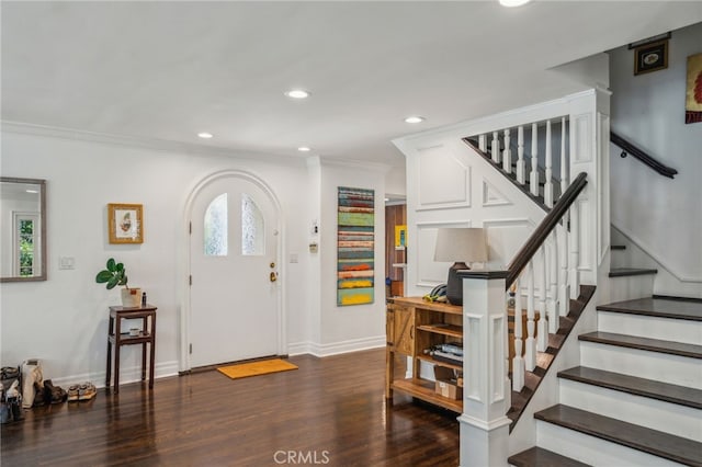 entryway with arched walkways, recessed lighting, stairway, ornamental molding, and wood finished floors